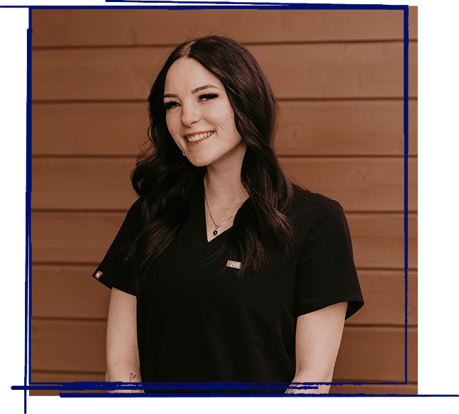 Tae smiles in professional headshot wearing black scrubs at West Jordan dental practice.