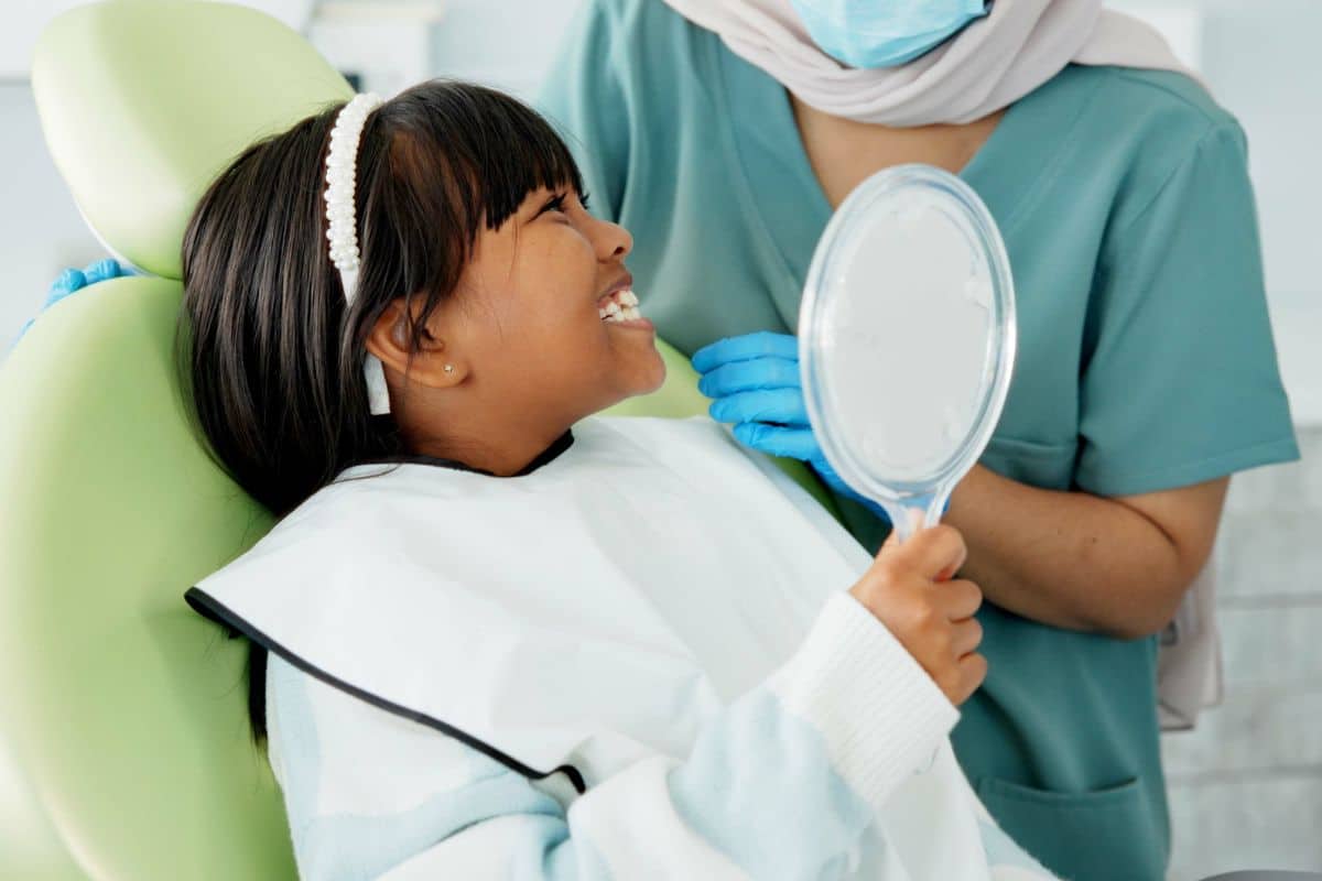 How Does a Children’s Dentist Guide Proper Brushing and Flossing for Kids?